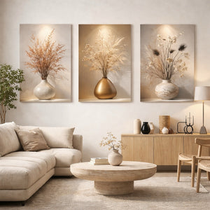 Three framed vertical canvas prints featuring dried floral arrangements in textured vases, displayed in a modern living room setting above a beige sofa and wooden console.